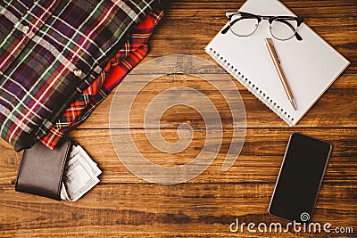 Pen and glasses on notepad smartphone next to shirt Stock Photo