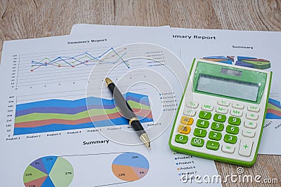 Pen graphs and calculators placed on the table. Concepts Data documents Graphs Graphs Marketing reports Research Development Stock Photo