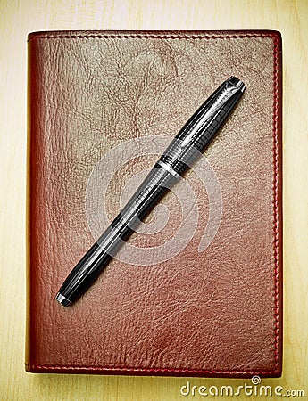 Pen on leather journal Stock Photo