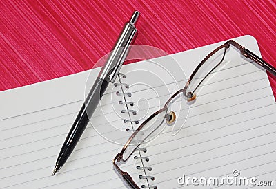 Pen, notebook and spectacles Stock Photo