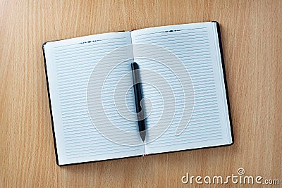 Pen on an open agenda or notebook with blank pages Stock Photo