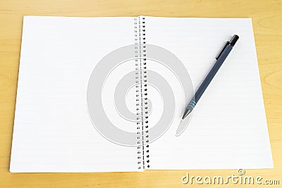 Pen and white blank paper block on table Stock Photo