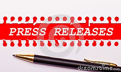 Pen and white torn paper strip on a bright red background with the text PRESS RELEASES Stock Photo