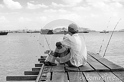 Penang, Malaysia, December 19 2017: Two Fishermen waiting for the catch of the day Editorial Stock Photo