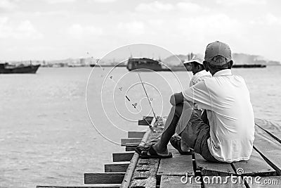 Penang, Malaysia, December 19 2017: Two Fishermen waiting for the catch of the day Editorial Stock Photo