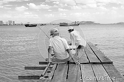 Penang, Malaysia, December 19 2017: Two Fishermen waiting for the catch of the day Editorial Stock Photo