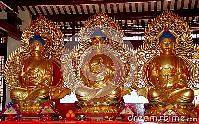 Penang, Malaysia: Three Gilded Buddhas at Chinese Temple Stock Photo
