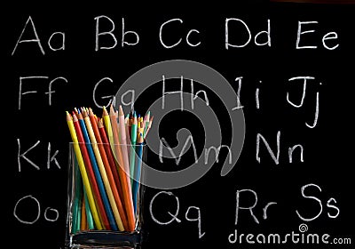 Pencil crayons with chalkboard background Stock Photo