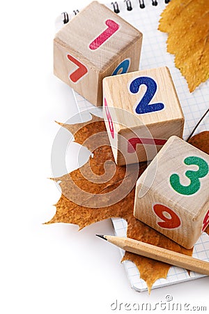 Pencil, cubes with figures and autumn leaves Stock Photo