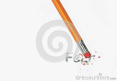 Pencil eraser erasing fear text on white paper Stock Photo