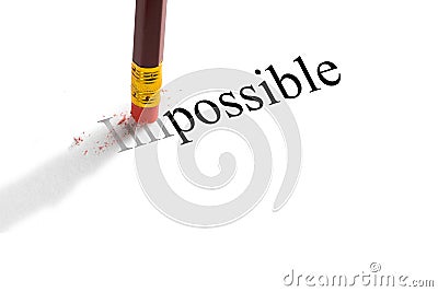 Pencil eraser trying to remove the word `impossible` on paper. Concept. Stock Photo