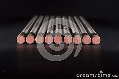 Pencil erasers on black surface Stock Photo