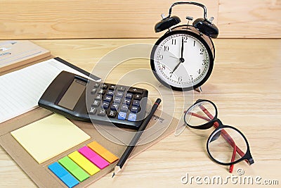 Pencil, folder file, Calculator, glasses clock on wood table concept Office equipment Stock Photo