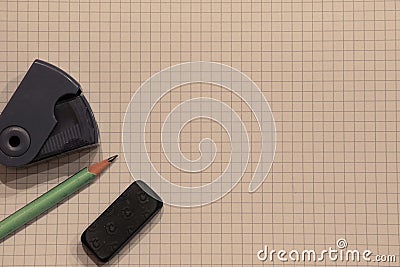 Pencil, pencil sharpener and an eraser on a white background with a square pattern with copyspace. Stock Photo