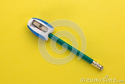 Pencil in sharpener on yellow background Stock Photo