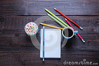 Pencils, coffee, cupcake and notebook Stock Photo