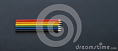 Pencils lie on top Bright social colors lgbt. LGBT colors corrugated cardboard flag Stock Photo