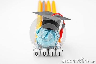 Pencils with QUIZ inscription. Paper education figure with graduation cap Stock Photo