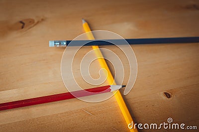 Pencils on table in the colours yellow, red and blue Stock Photo