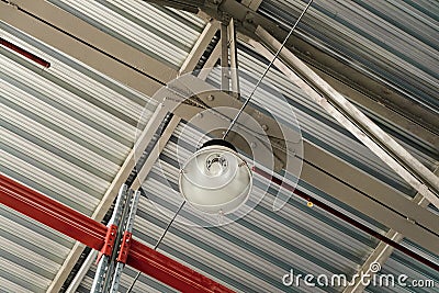 Pendant light on metal trusses covering an industrial long-span building Stock Photo