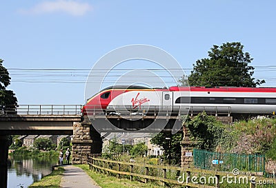 Pendolino electric train crossing Lancaster canal Editorial Stock Photo