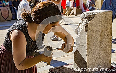 Penedono , Portugal - July 1, 2017 - Woman carves new sculpture in annual Medieval fair Editorial Stock Photo