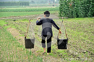 Pengzhou, China: Barefoot Woman in Farm Field Editorial Stock Photo