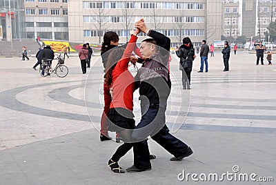 Pengzhou, China: Couple Dancing Outdoors in Plaza Editorial Stock Photo
