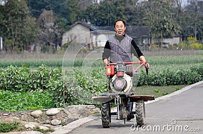 Pengzhou, China: Farmer with Motorised Tiller Editorial Stock Photo