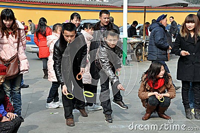 Pengzhou, China: People Playing Ring Toss Editorial Stock Photo