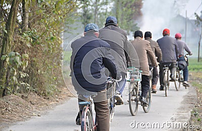 Pengzhou, China: Six Men on Bicycles Editorial Stock Photo