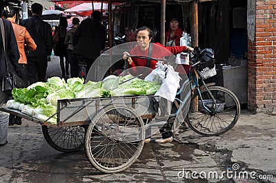 Pengzhou, China: Woman Selling Cabbages Editorial Stock Photo