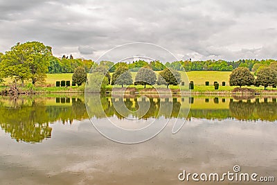 Penhurst Lake reflections on a cloudy day Stock Photo