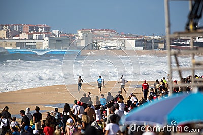 Peniche, Portugal - Oct 25th 2017 - A surfer running at the sand during the World Surf League`s 2017 MEO Rip Curl Pro Portugal su Editorial Stock Photo