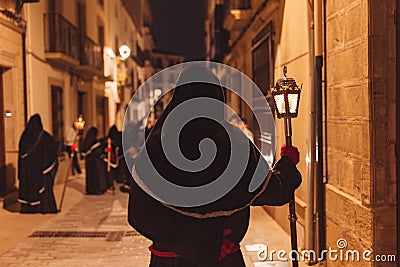 Penitent with his back turned in procession Stock Photo