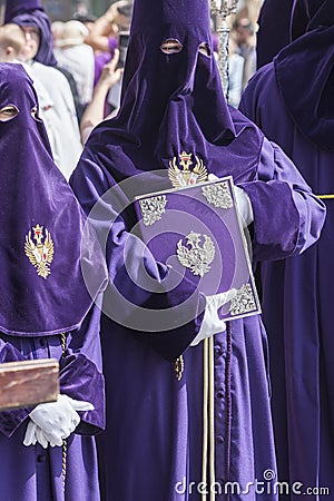 penitent with the rule book governing the brotherhood with velvet caps and appliques of embossed silver, Spain Editorial Stock Photo