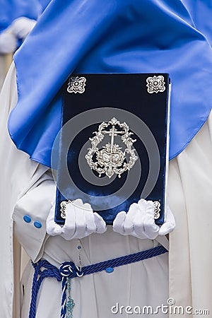 Penitent with the rule book governing the brotherhood with velvet caps and appliques of embossed silver Editorial Stock Photo