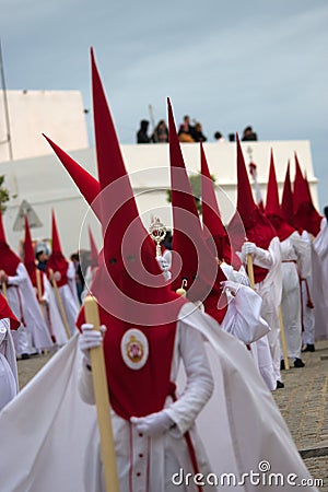 Penitents of the brotherhood of Saint Blas in a procession. Carmona, Seville Editorial Stock Photo