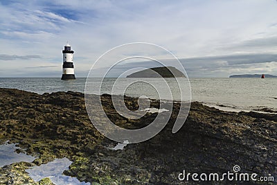 Penmon Beach, Anglesey, Wales. Lighthouse and Puffin Island. Stock Photo