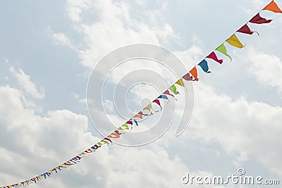 Pennant String with white clouds in blue sky Stock Photo