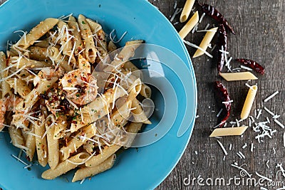 Penne with garlic and oil aglio e olio. Spicy pasta with prawns and cheese Stock Photo