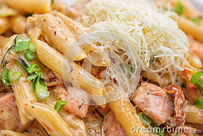 Penne pasta bolognese with parmesan, served on white plate Stock Photo