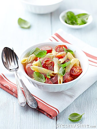 Penne pasta with roasted cherry tomatoes Stock Photo