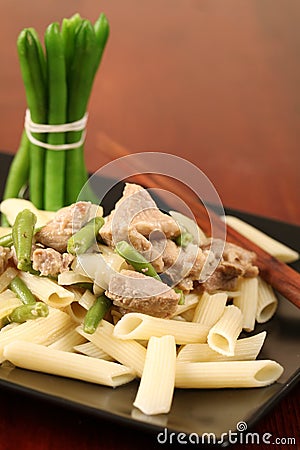 Penne rigate with pork and green beans Stock Photo