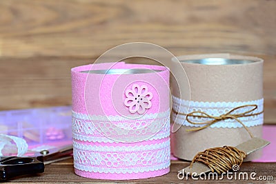 Pens and scissors holders. Creative recycled tin cans for storage of stationery. Decoration tin cans using a felt, lace and button Stock Photo