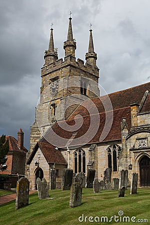 Dark clouds over Penshurst church Stock Photo