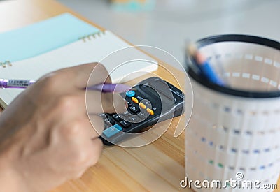 Pension calculation concept, old hands counting finances on a home calculator , close- up Stock Photo