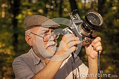 Pension hobby. Experienced photographer. Vintage camera. Old man shoot nature. Professional photographer. Make perfect Stock Photo