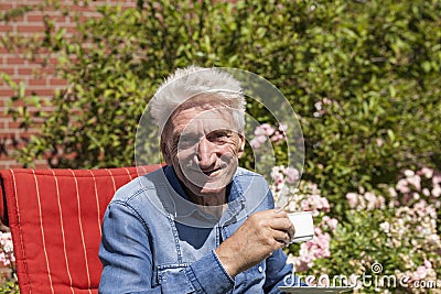 Pensioner drinking coffee Stock Photo