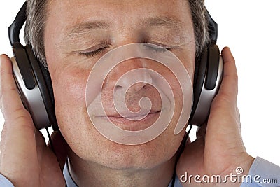 Pensioner with headphones listening to mp3 music Stock Photo